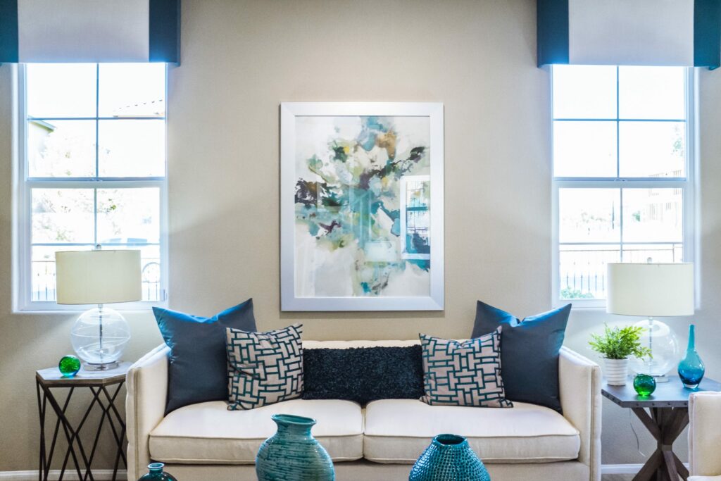 Upholstery Los Angeles white sofa in living room with blue throw pillows